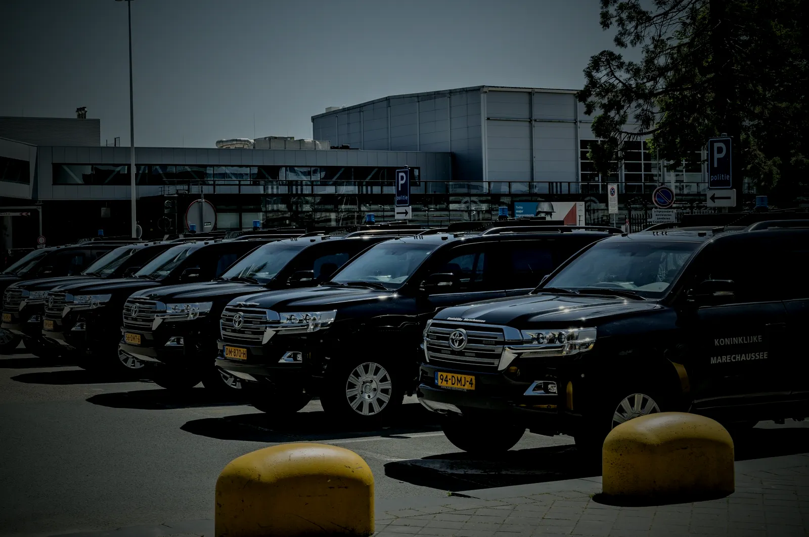 A row of black SUVs parked at a fleet lot