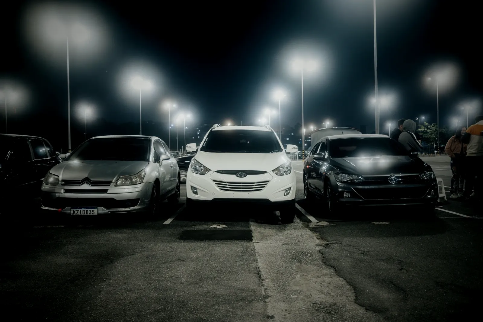 Cars, SUVs and minivans on a dealer lot at night