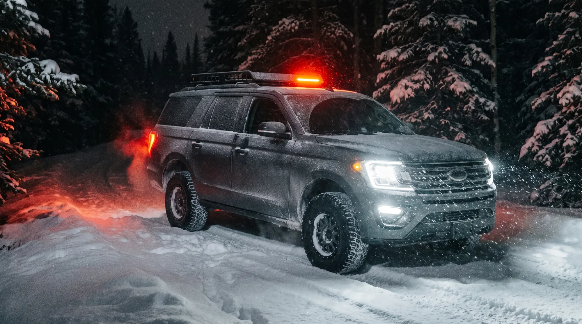 Grey SUV driving through deep snow at night